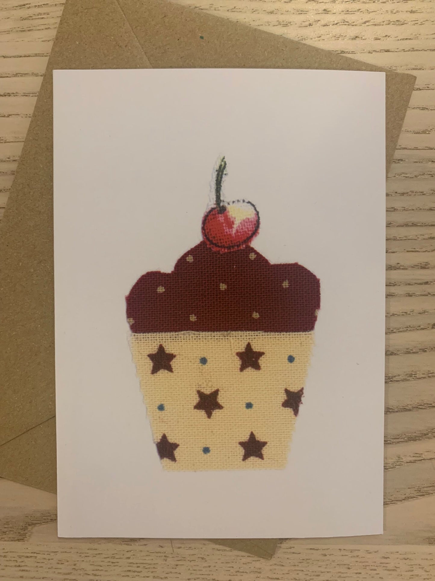 Card - Cupcake hand made &nbsp;Cupcake  Card from an original fabric collage &nbsp;by Danielle Mason-Pike  £2.50  Greetings Card with Brown Kraft Envelope  Blank inside for your own message  Exclusive to Seawitch Stores  Designed &amp; Printed in Cornwall