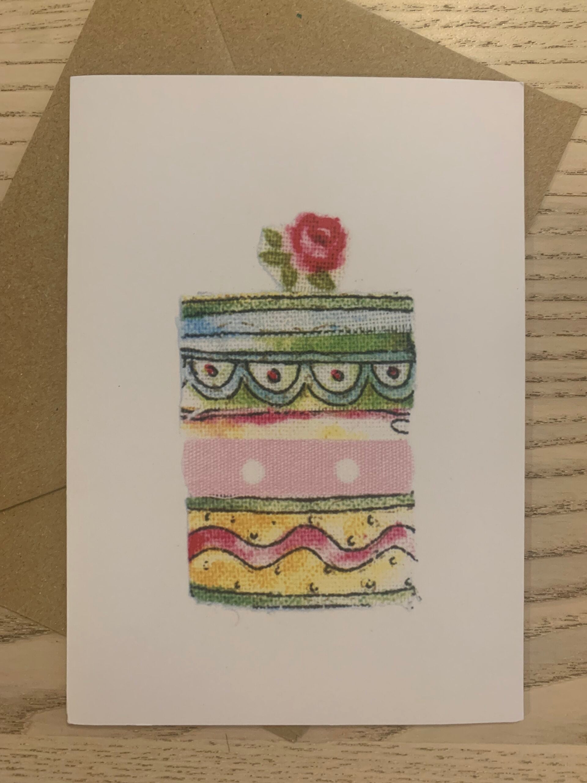 Card - Layer Cake birthday greetings card Layer Cake Card from an original fabric collage by Danielle Mason-Pike  £2.50  Greetings Card with Brown Kraft Envelope  Blank inside for your own message  Exclusive to Seawitch Stores  Designed &amp; Printed in Cornwall