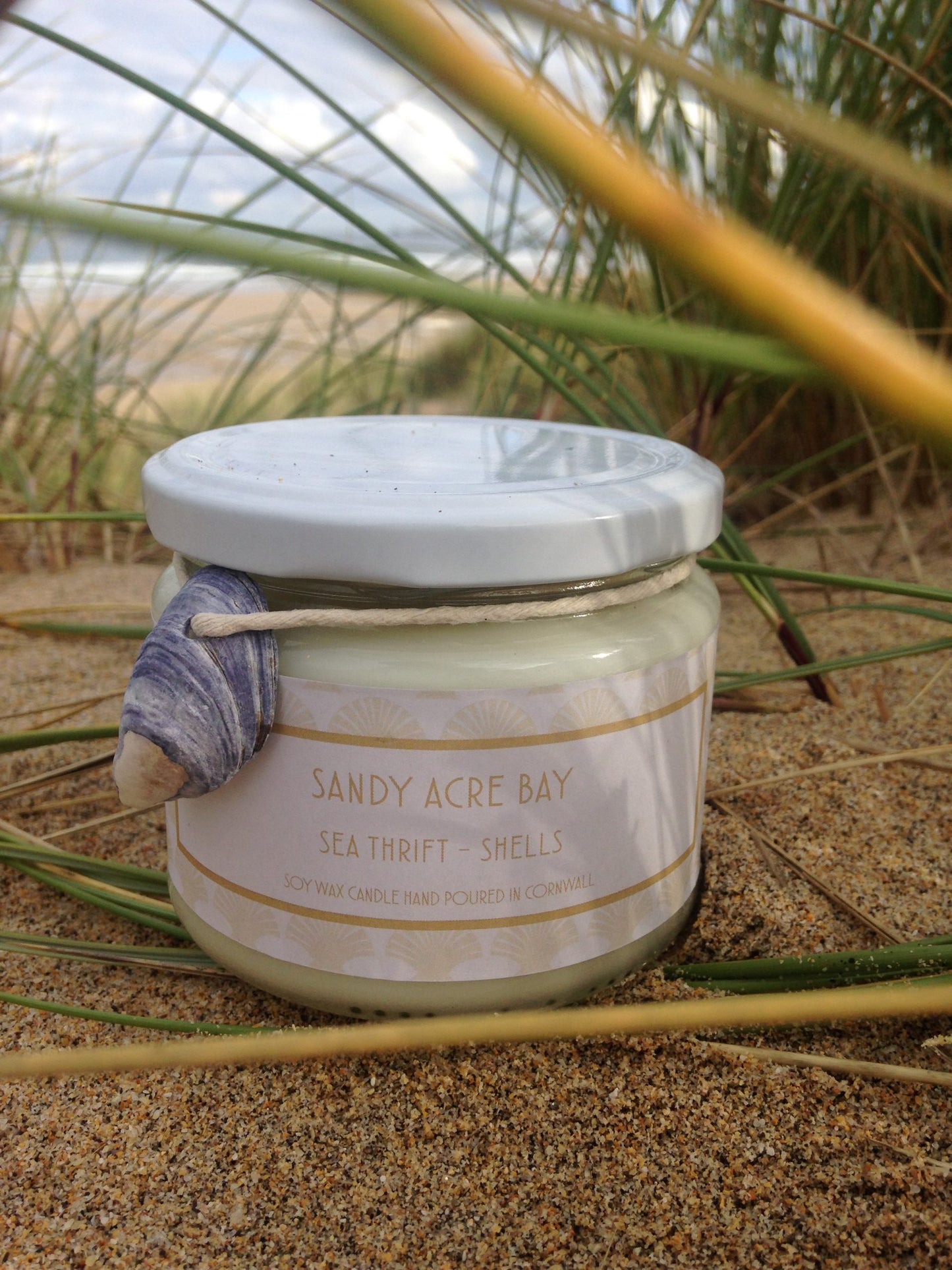 Sandy Acre Bay Candle  £20  Sea Thrift – Shells  Cool sea air and salty pebbles mingle with the delicate floral's of dune grass and sea thrift  Ingredients: natural plant wax, fragrance oils  Shell may vary to image shown  Double wicked plant wax candle . Burns for approx 40 hours. Made in Cornwall by Seawitch Candles    "Love love love this candle - best candle I have ever bought and I have bought a LOT of candles !!!!" Davina Davies coastal life, coastal living, coastal style